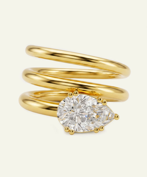 Gold spiral ring with a diamond on a white background