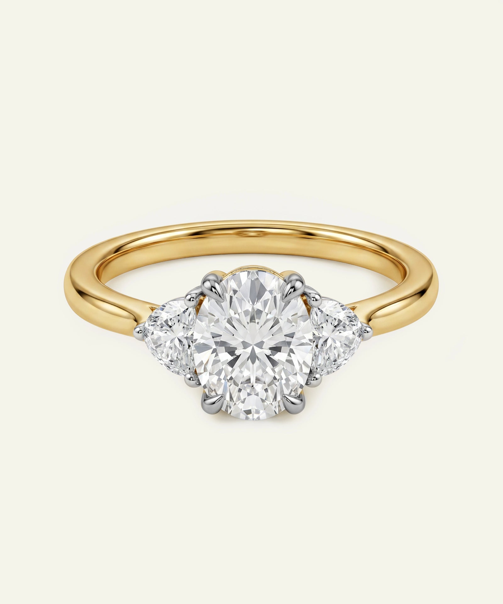 Oval diamond three-stone engagement ring with a yellow gold band