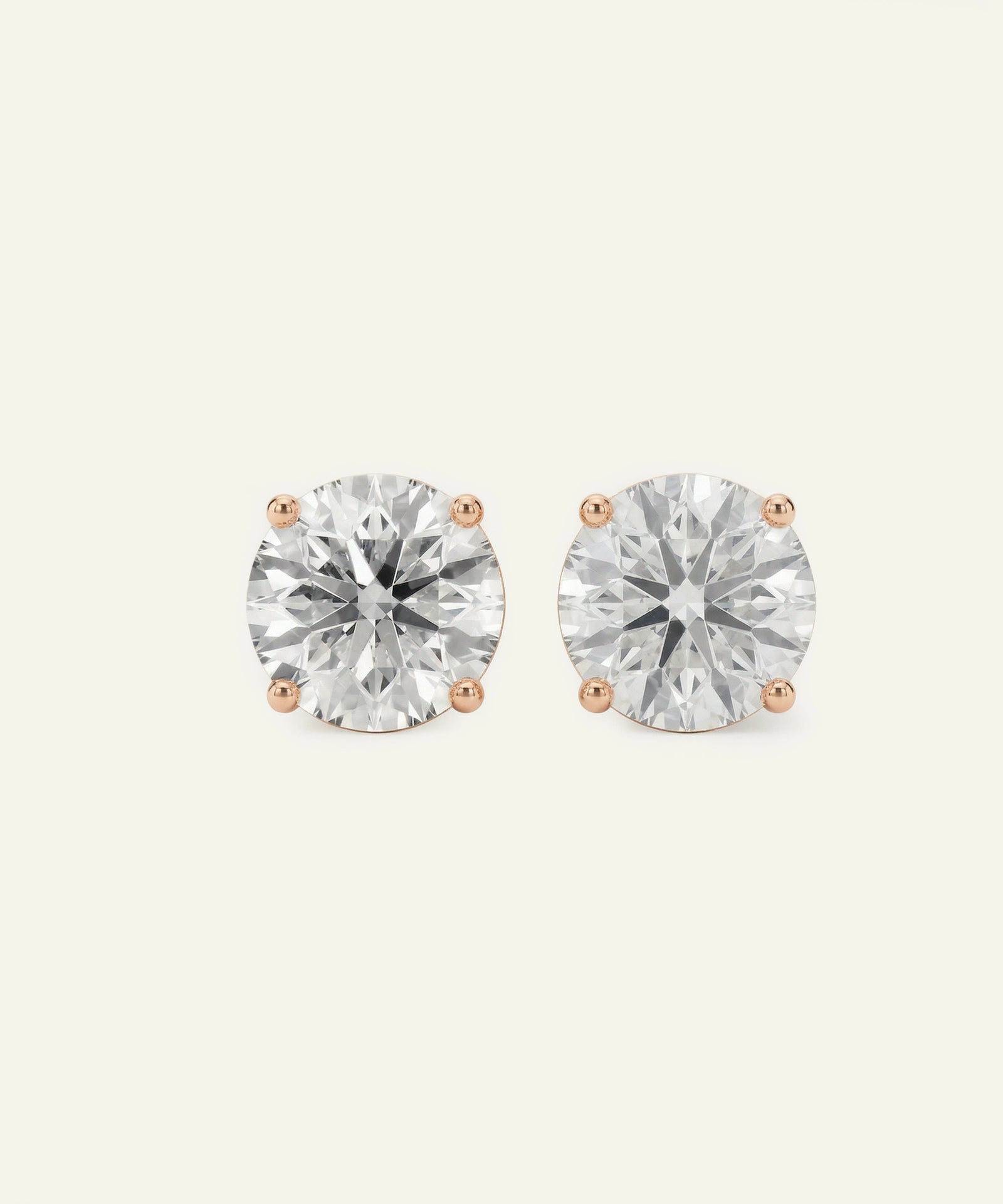 Pair of diamond stud earrings on a light gray background