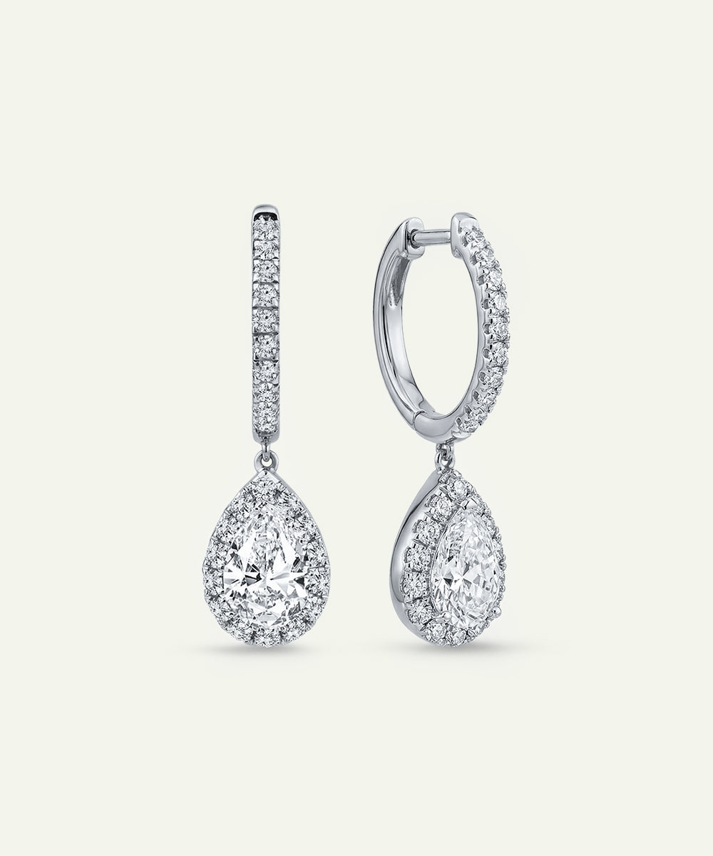 Pair of diamond earrings on a light gray background