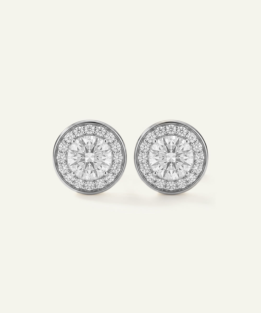 Pair of diamond stud earrings on a light gray background