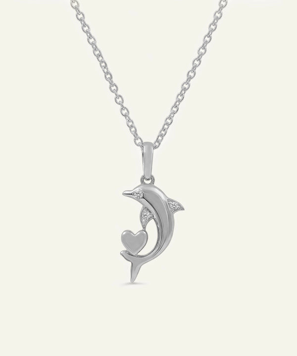 Silver pendant shaped like a dolphin with a heart on a white background
