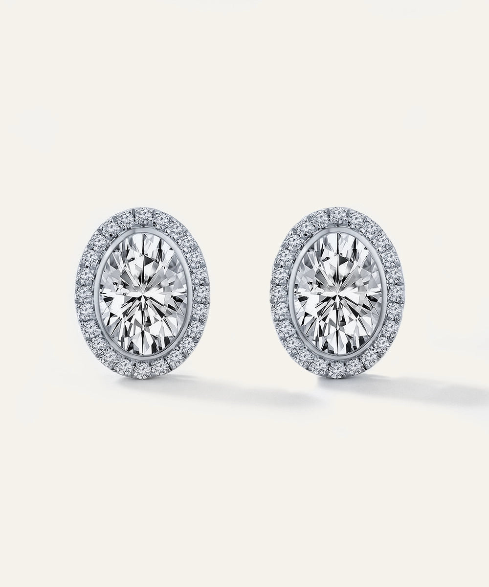 Pair of diamond earrings on a light gray background