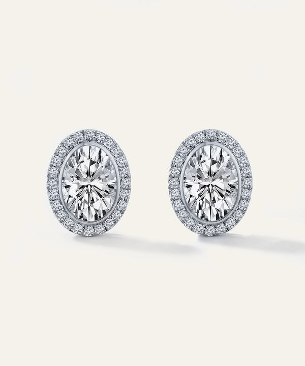 Pair of diamond earrings on a light gray background