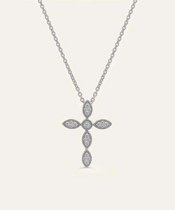 Silver cross pendant necklace on a light gray background