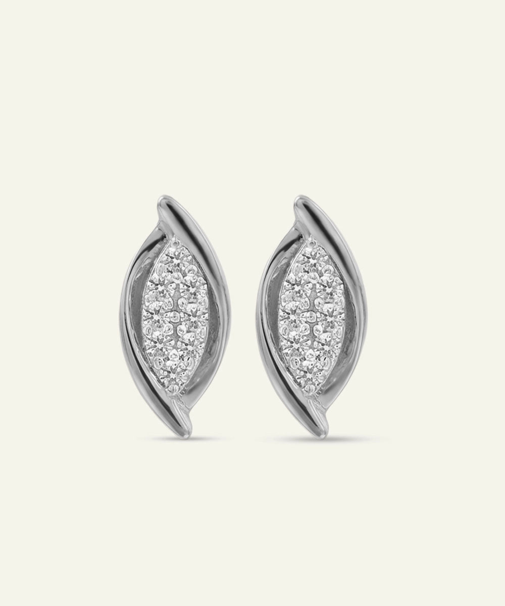 Pair of silver earrings with diamond accents on a light gray background