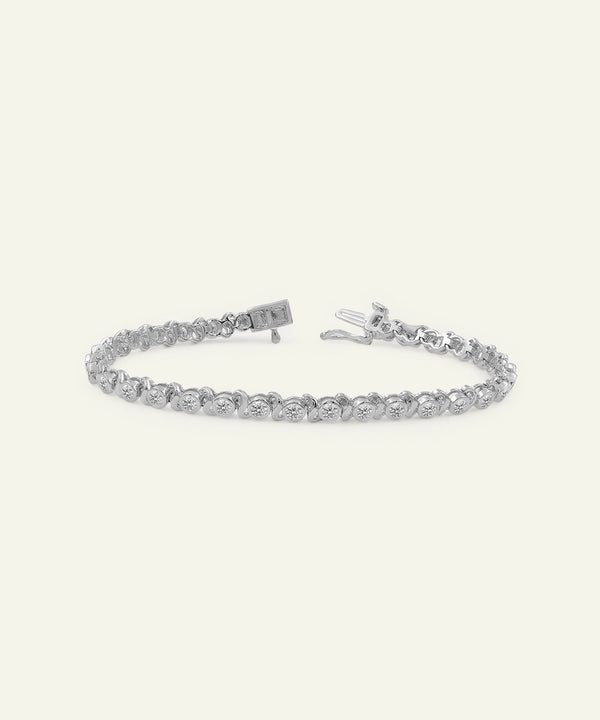 Silver bracelet with clear stones on a white background