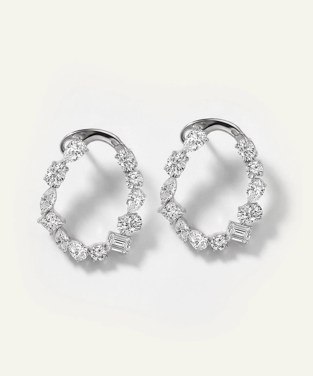 Pair of diamond hoop earrings on a light gray background