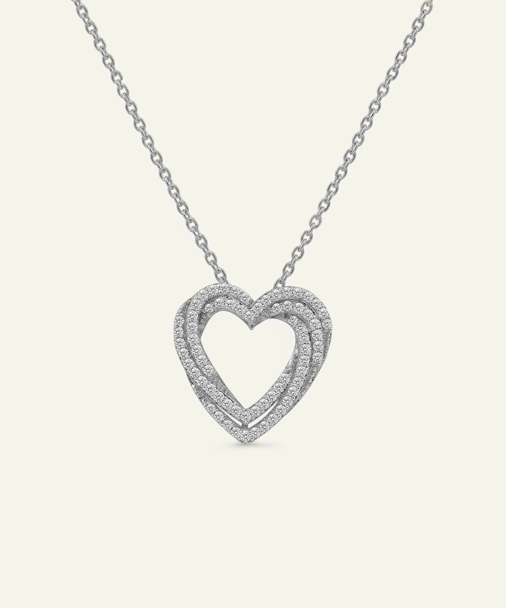 Heart-shaped diamond necklace on a white background