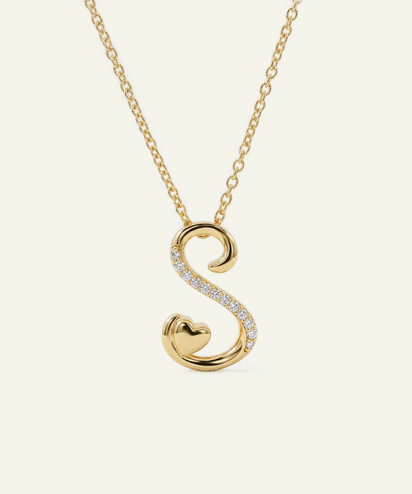 Gold necklace with a 'S' shaped pendant on a white background