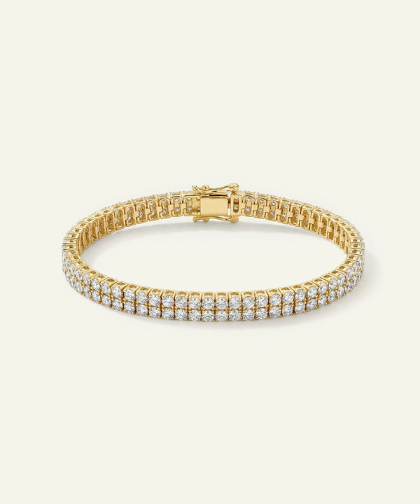 Gold bracelet with clear stones on a white background