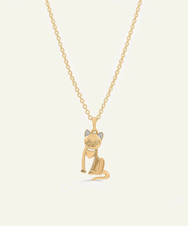 Gold cat-shaped pendant necklace on a light beige background