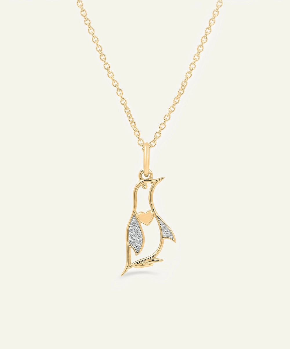Gold necklace with a leaf-shaped pendant on a white background