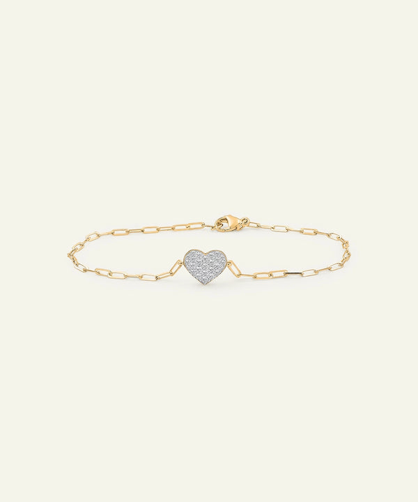 Gold bracelet with a heart-shaped charm on a white background