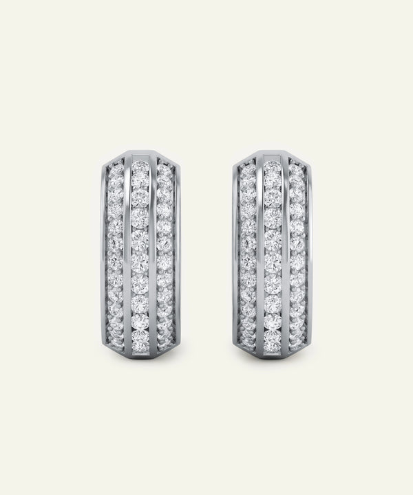 Pair of diamond earrings on a light gray background
