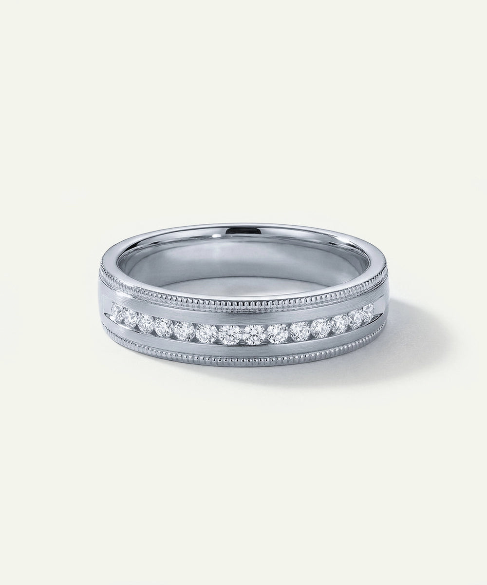 Silver ring with diamonds on a light gray background