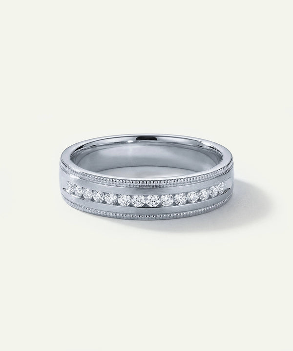 Silver ring with diamonds on a light gray background