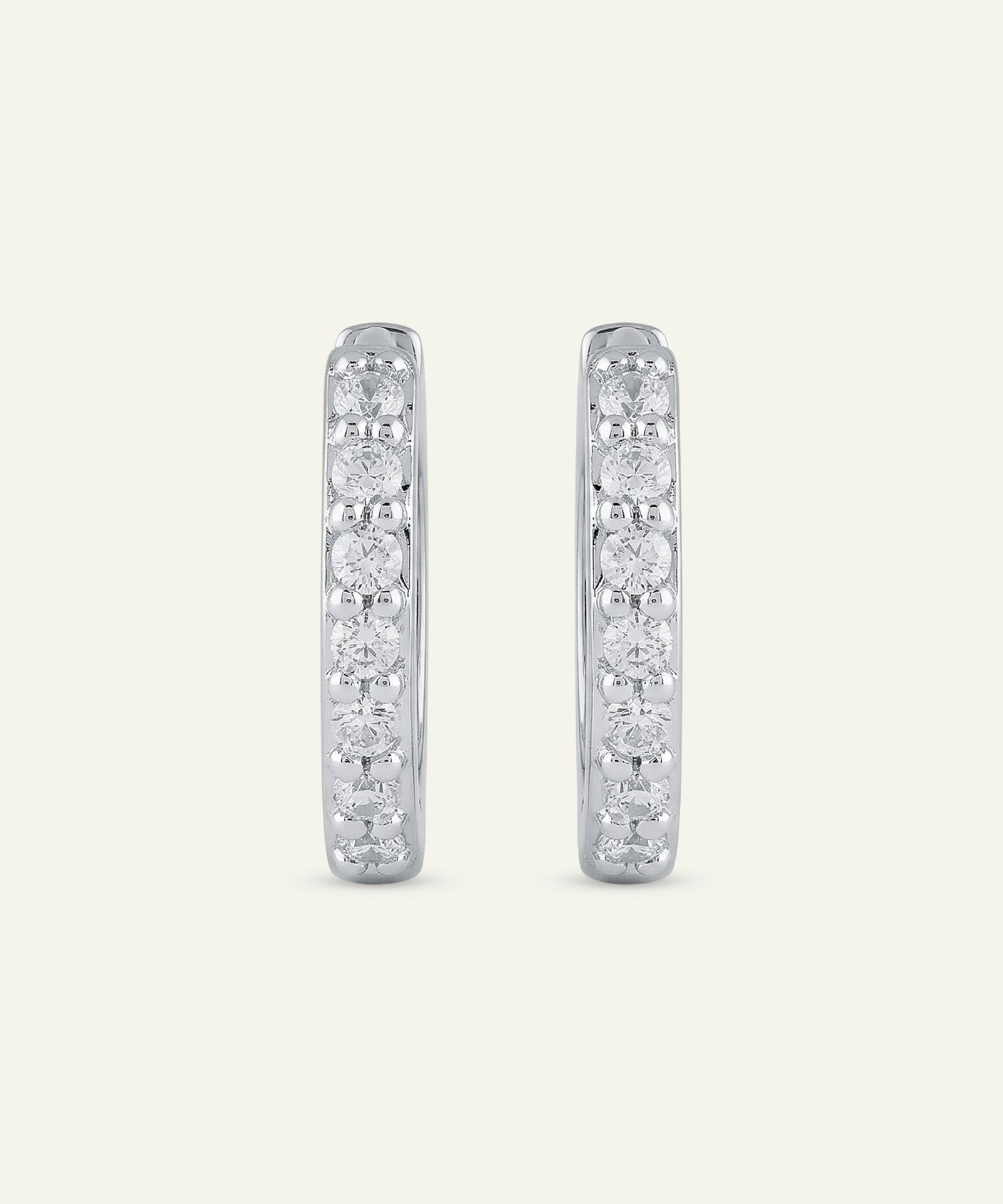 Pair of diamond hoop earrings on a light gray background