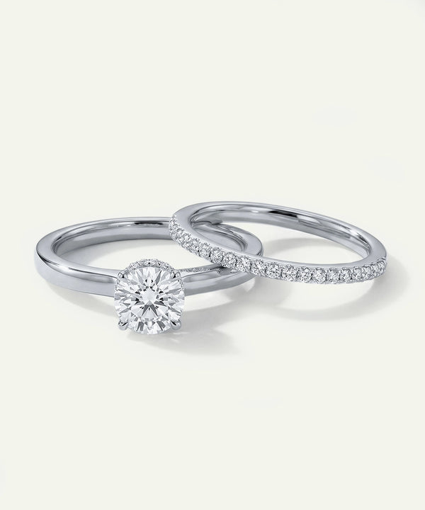 Two silver rings with diamond accents on a light gray background