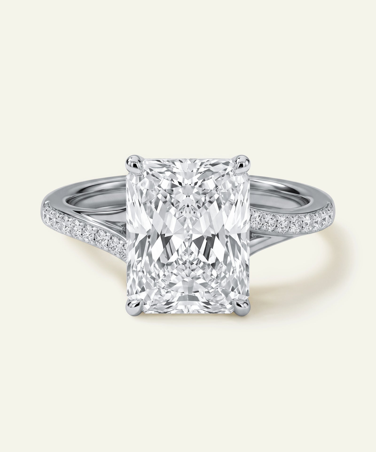 Radiant-cut diamond ring with a crossover pavé band.