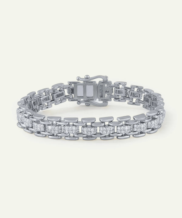 Silver bracelet with diamond accents on a white background