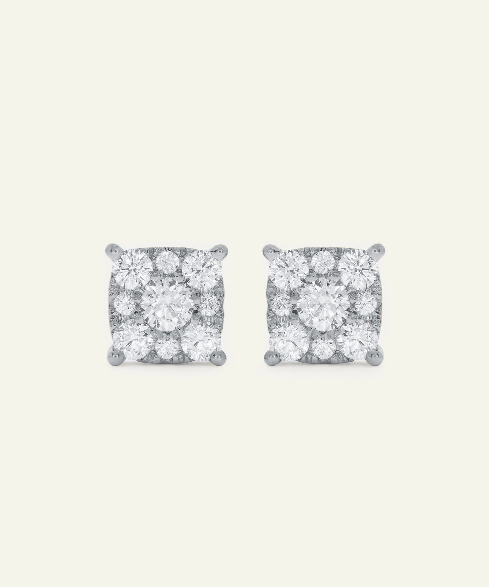 Pair of diamond stud earrings on a light gray background
