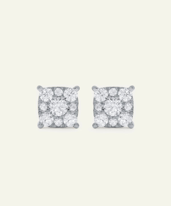 Pair of diamond stud earrings on a light gray background