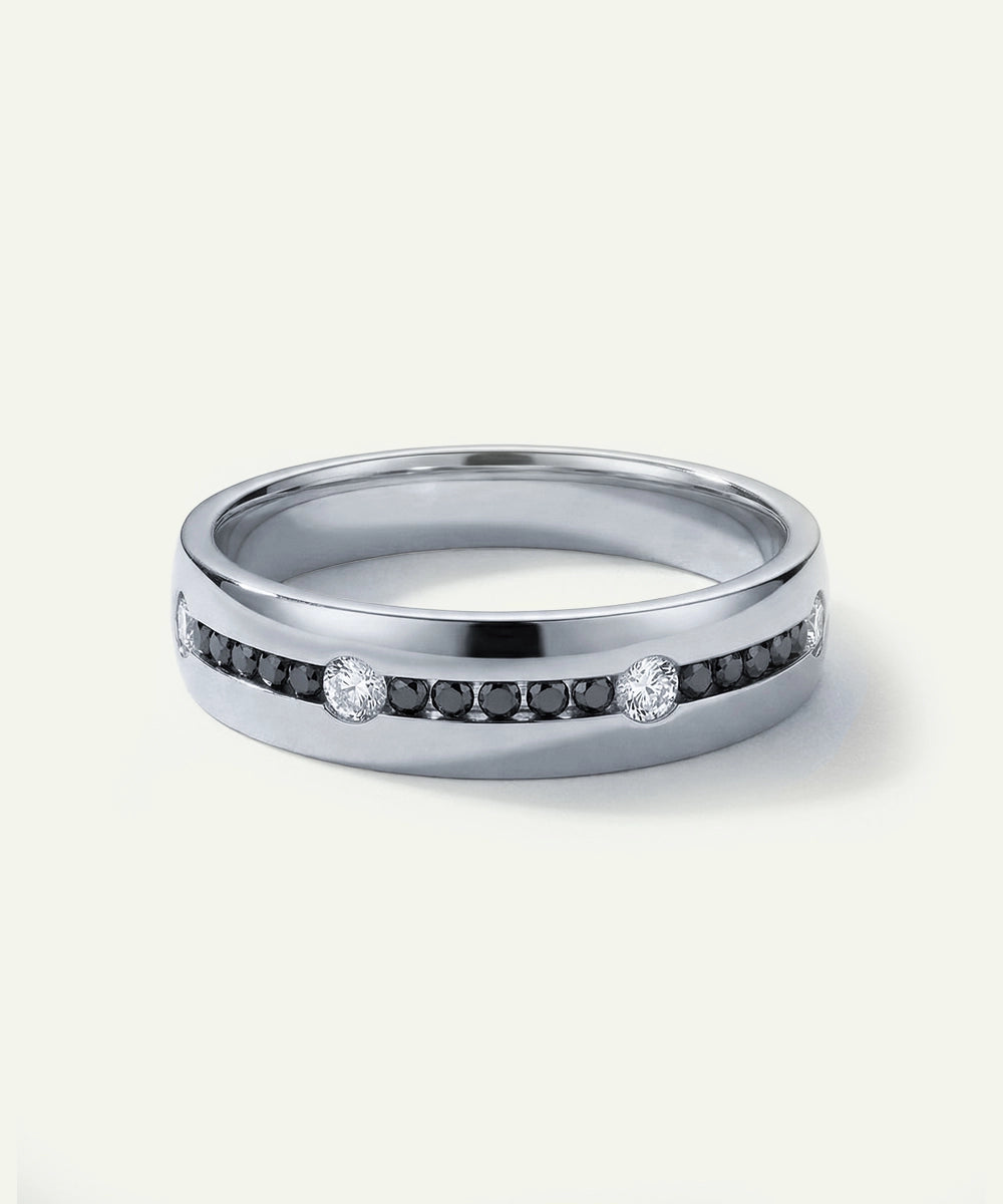 Silver ring with embedded diamonds on a white background