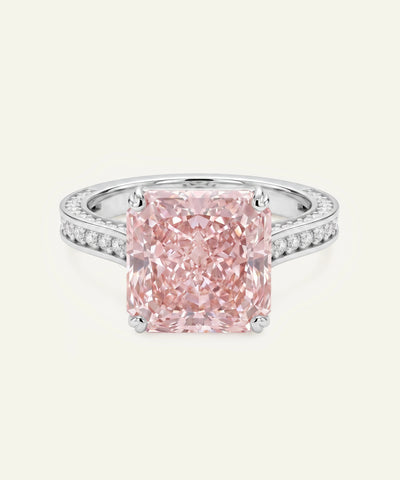 Pink diamond ring with a white gold band on a light gray background