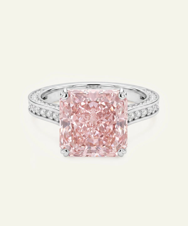 Pink diamond ring with a white gold band on a light gray background