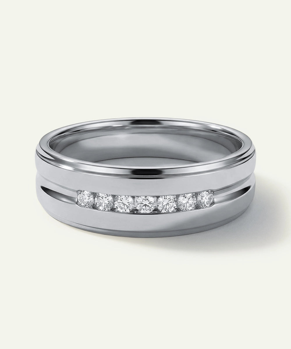 Silver ring with embedded diamonds on a white background