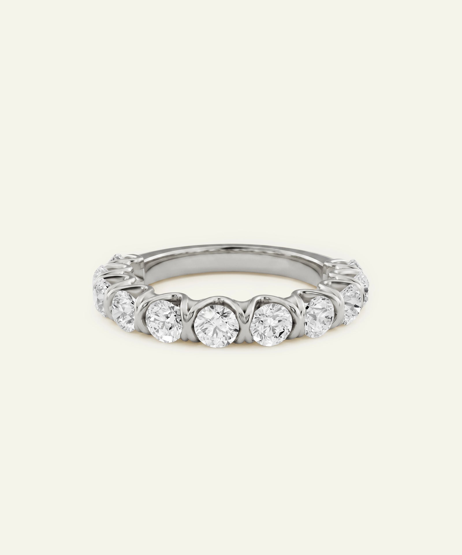 A silver-toned diamond eternity ring with five round-cut diamonds set in a continuous band, shown against a plain off-white background.
