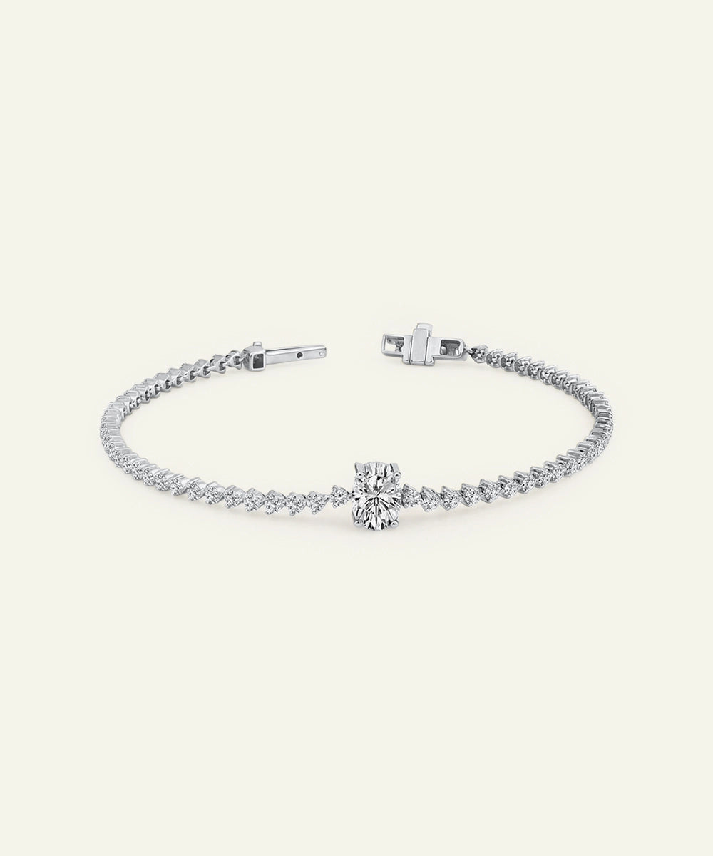 Silver bracelet with a bow charm on a white background