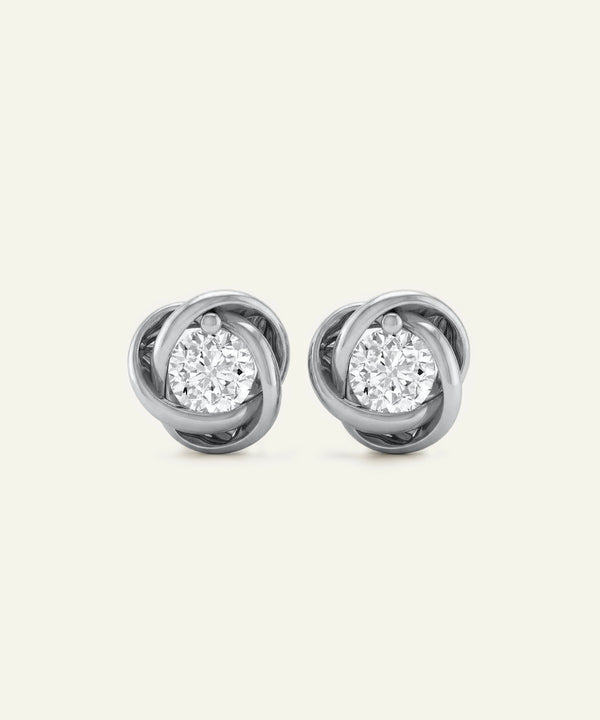 Pair of diamond stud earrings on a light gray background