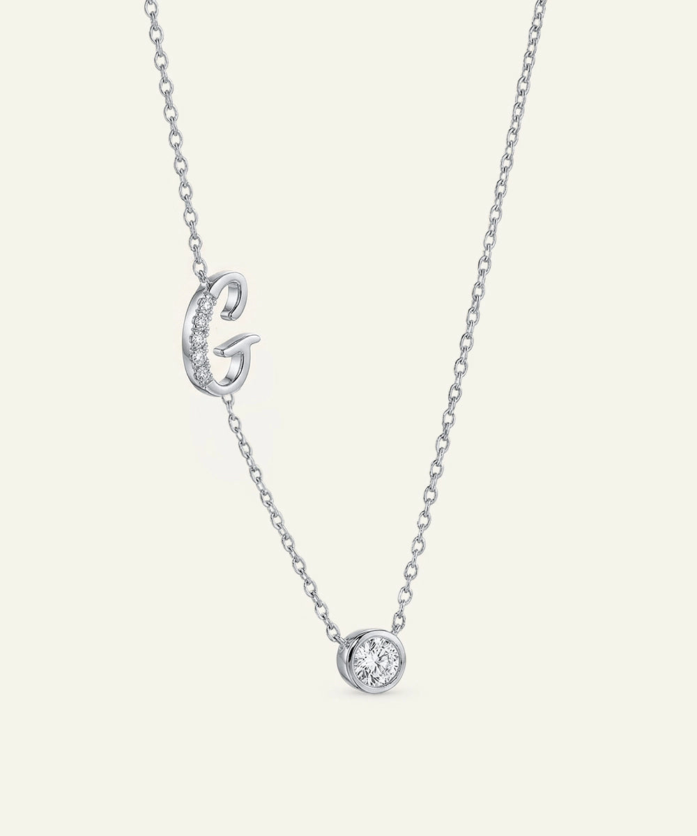 Silver necklace with a 'G' pendant on a white background