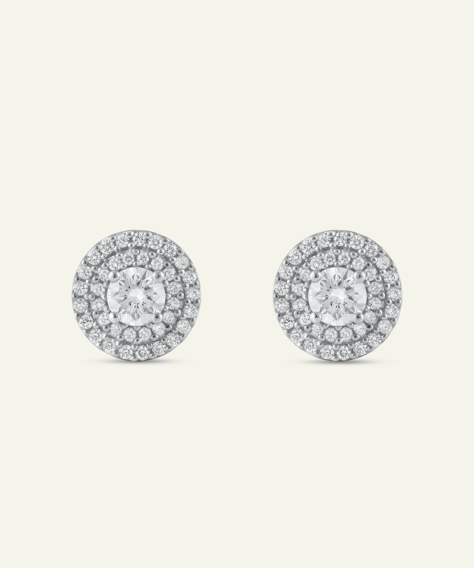 Pair of diamond stud earrings on a light gray background