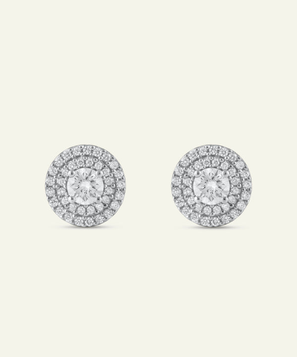 Pair of diamond stud earrings on a light gray background