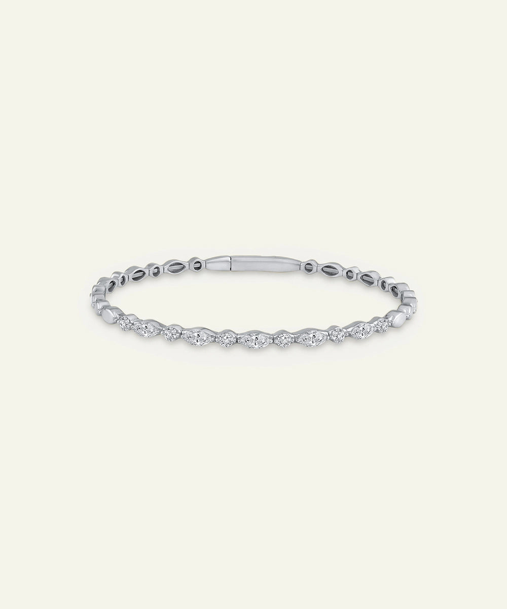Silver bracelet with clear stones on a light gray background