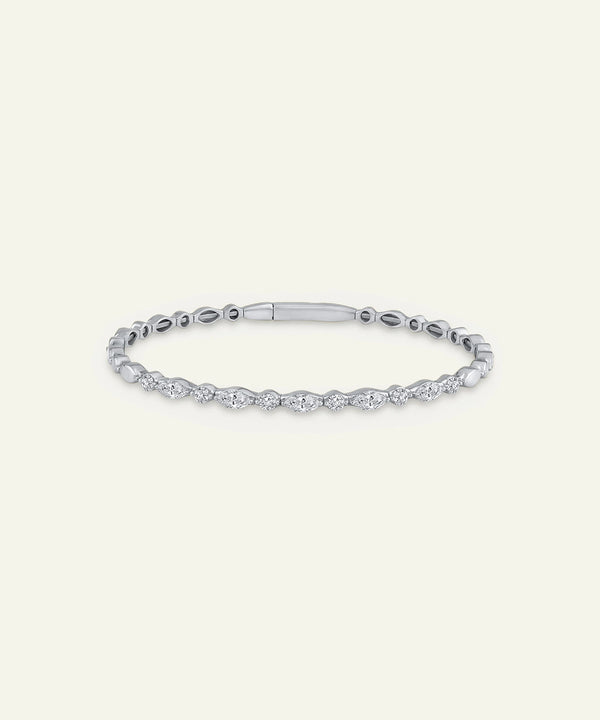 Silver bracelet with clear stones on a light gray background