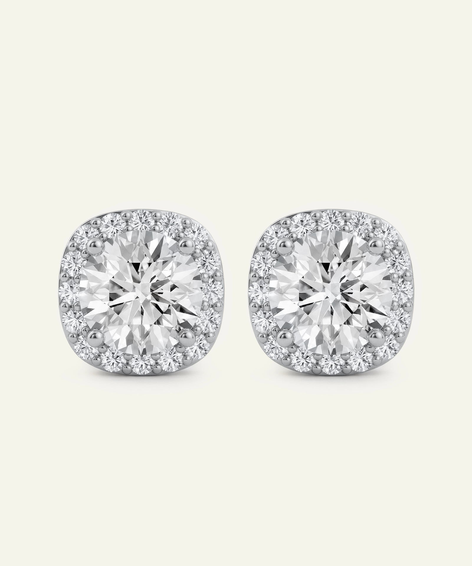 Pair of diamond stud earrings on a light gray background