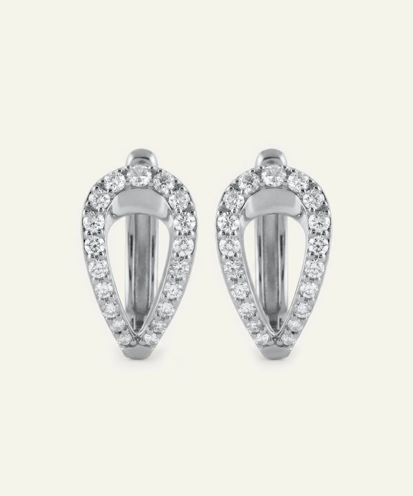Pair of silver earrings with clear gemstones on a white background