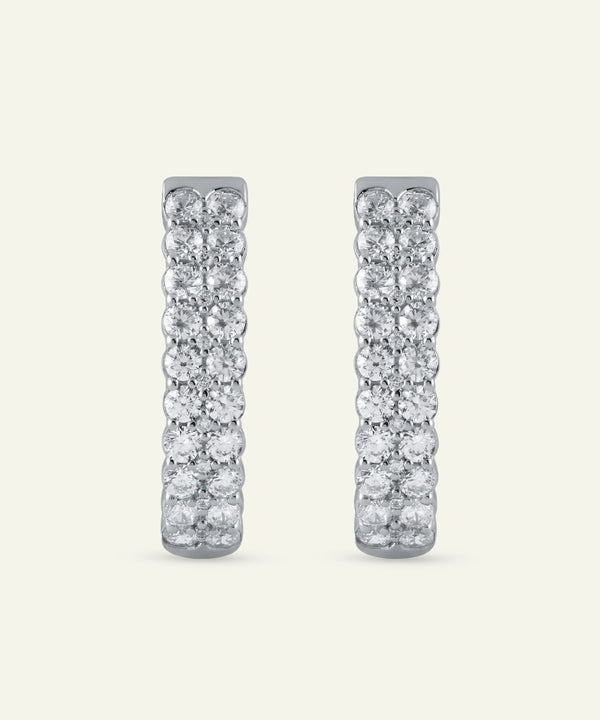 Pair of diamond earrings on a light gray background