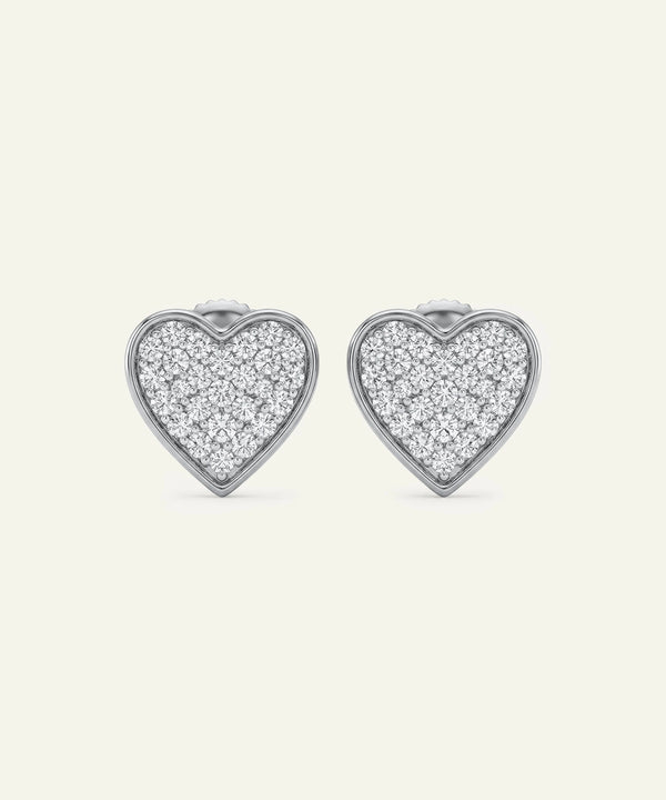 Heart-shaped earrings with diamond pavé on a white background