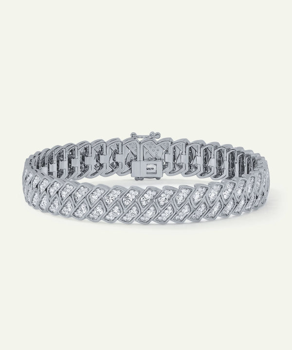 Silver bracelet with diamond accents on a white background