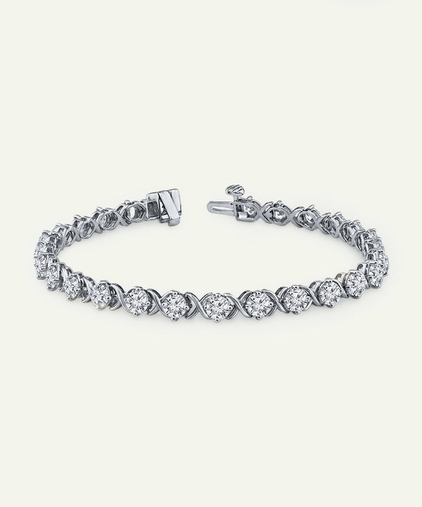 Silver bracelet with clear gemstones on a white background