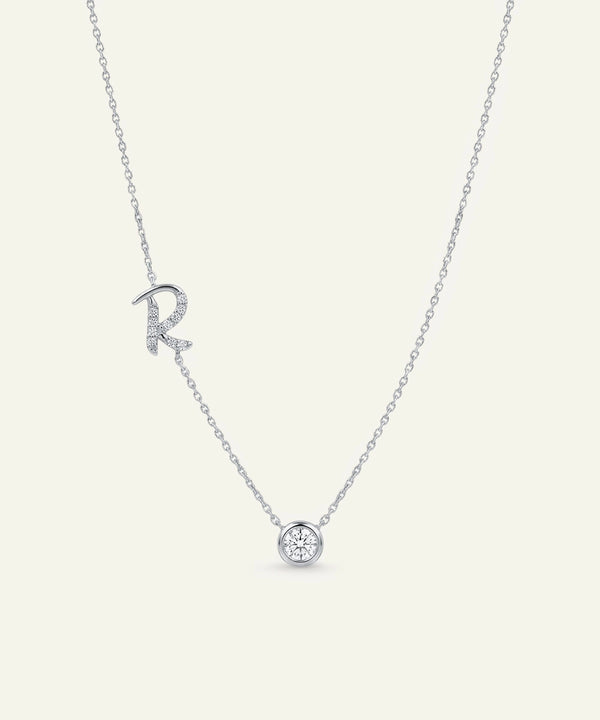 Silver necklace with a heart pendant on a light gray background