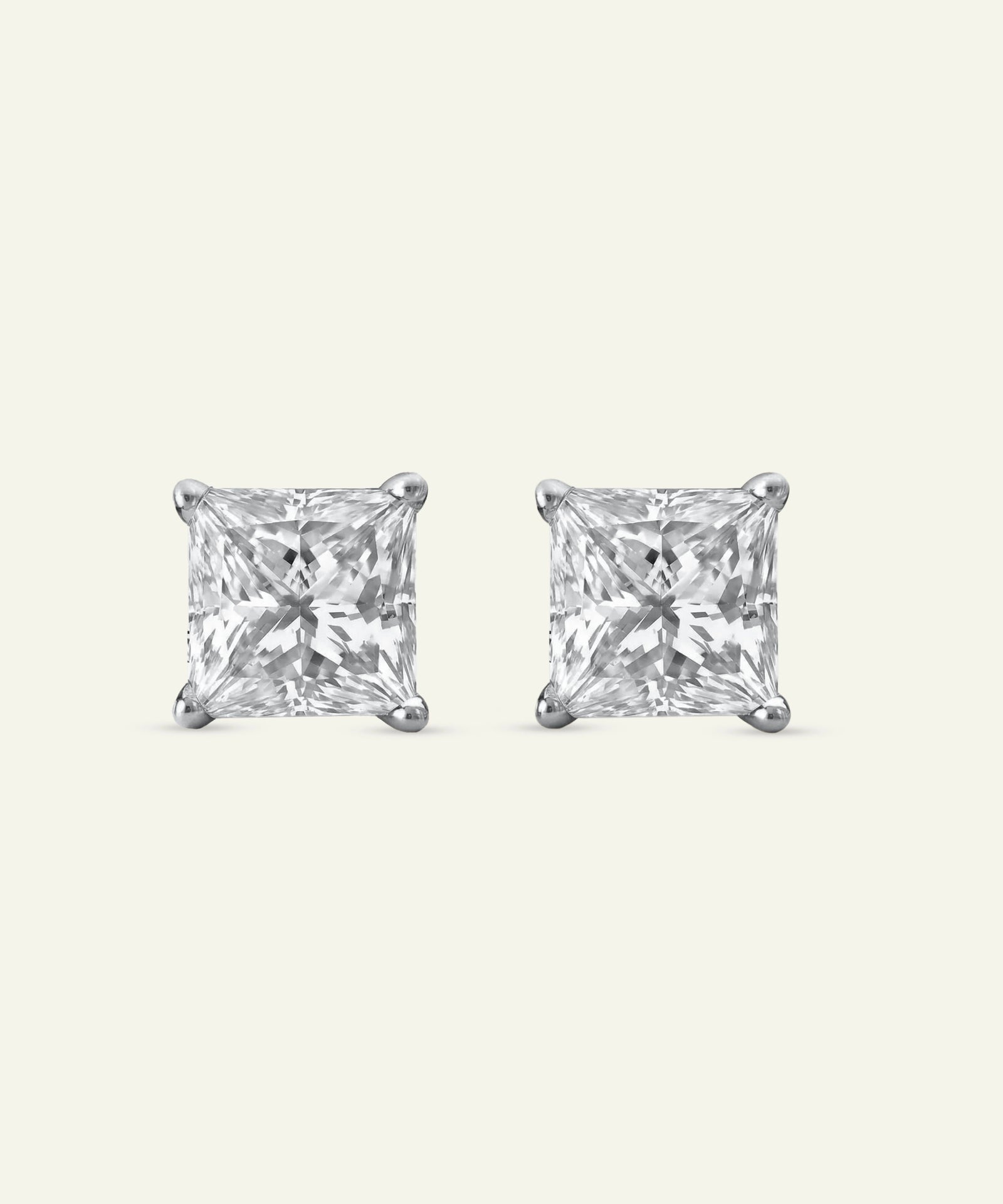 Pair of square-cut stud earrings on a light gray background