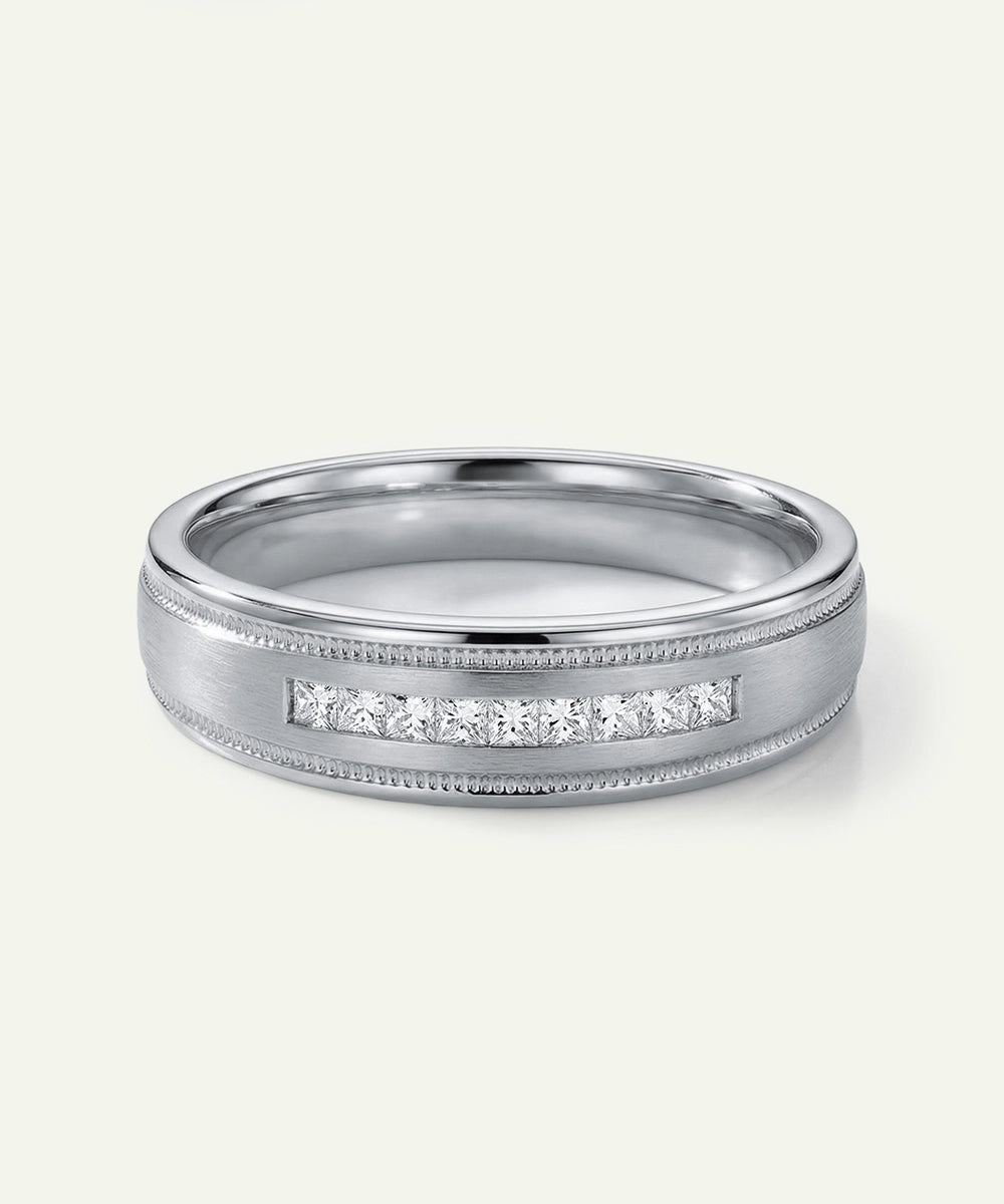 Silver ring with diamond accents on a white background