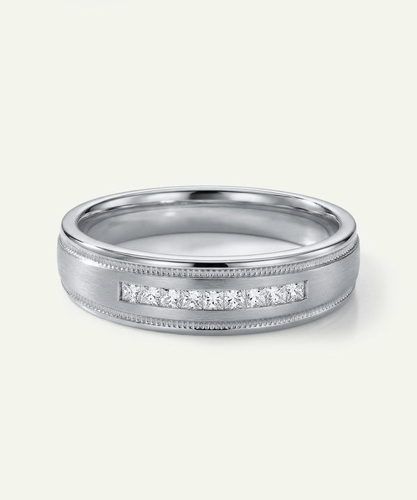 Silver ring with diamond accents on a white background