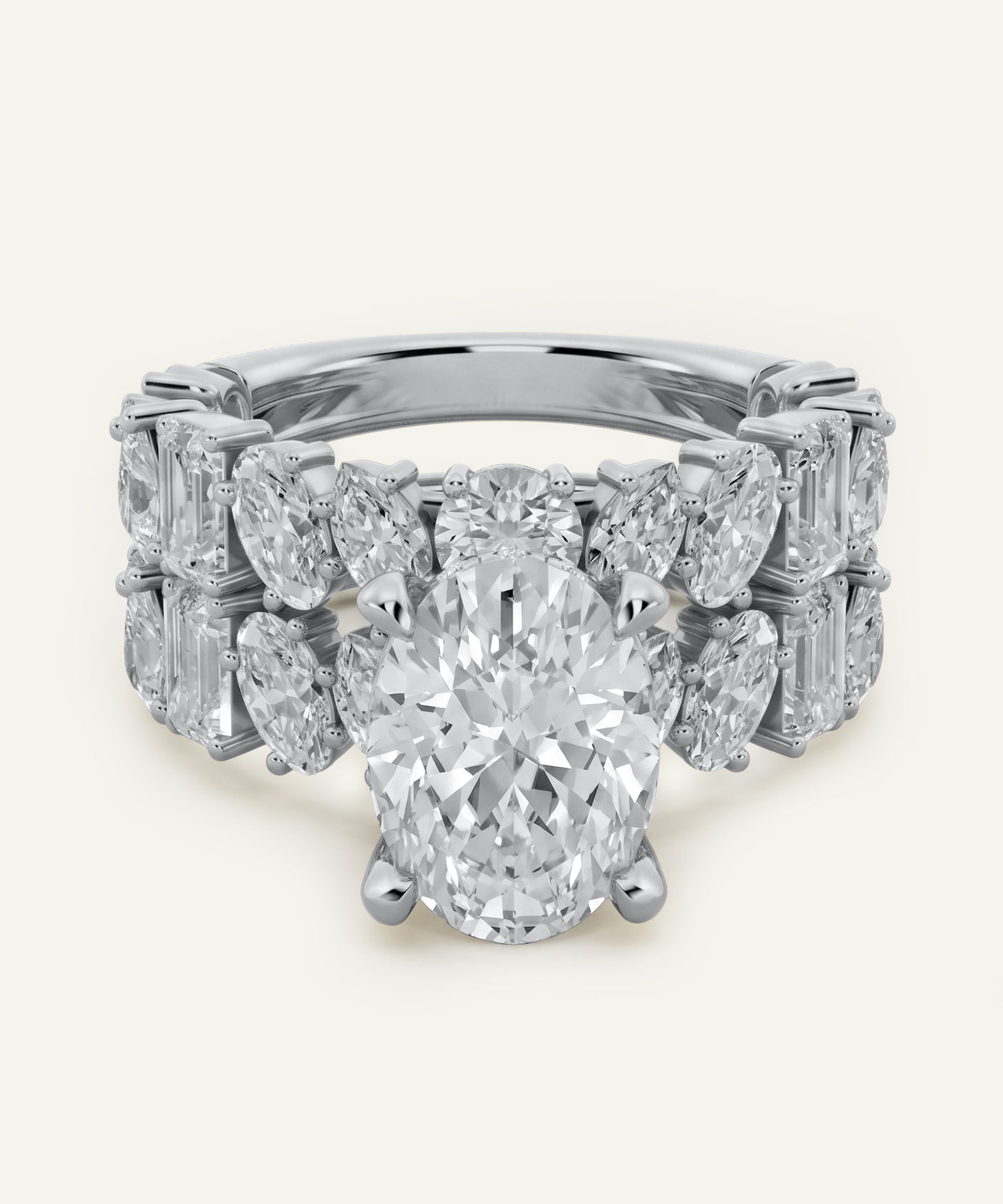 Oval-cut center diamond engagement ring in white metal, featuring a wide band adorned with marquise-cut and emerald-cut side diamonds in a symmetrical, multi-row design. The ring is shown from the front against a light neutral background.